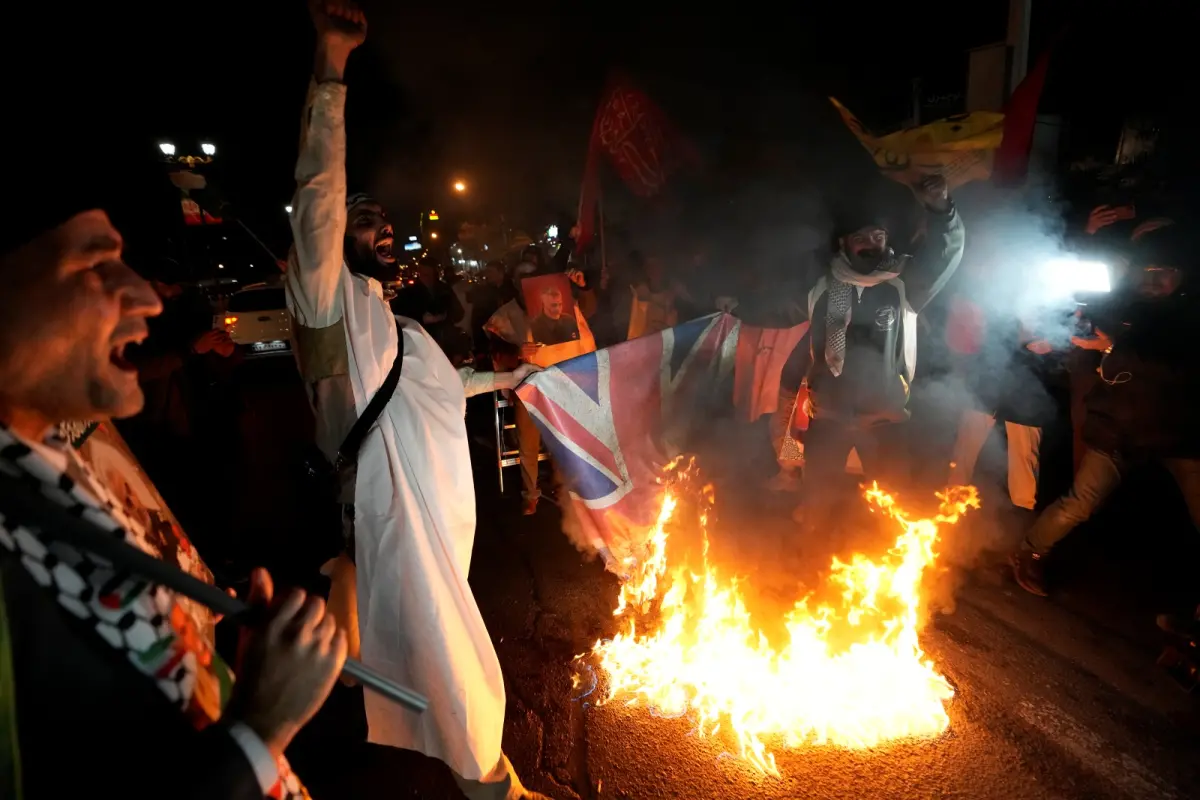 ▲英美聯合空襲葉門胡塞組織一事引發不少爭議，圖為伊朗民眾在空襲事件後，於英國大使館前，焚燒英國國旗抗議。（圖／美聯社／達志影像）