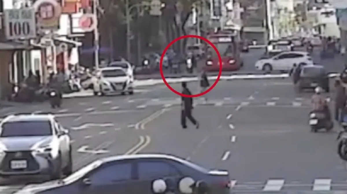 ▲高雄市一名吳姓男子昨天下午相當悠閒地穿梭在高雄市三民區熱河一街與自由一路口，像在逛街一樣。(圖／記者郭凱杰翻攝)