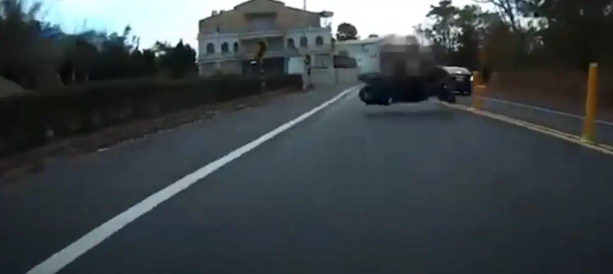 ▲高雄一名機車騎士疑似壓到路面油漬，導致失控摔倒撞上對向來車。（圖／翻攝地圖型行車影像分享平台）