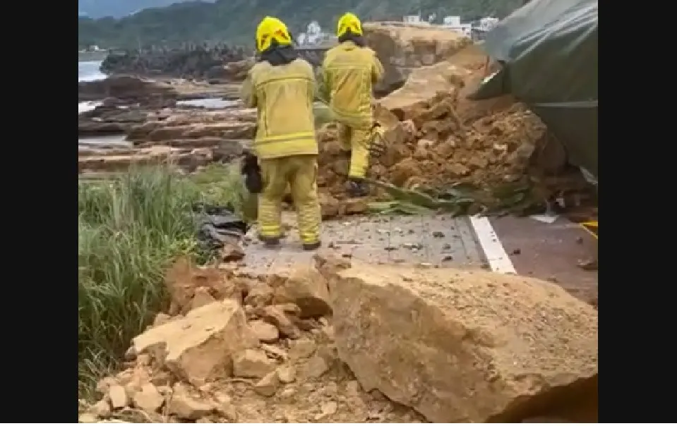 ▲3日下午2時許，基隆市潮境公園大橋入口處，發生大片土石崩落，瞬間整片山壁、巨石不斷落下，壓毀下方多輛汽車。（圖／翻攝畫面）