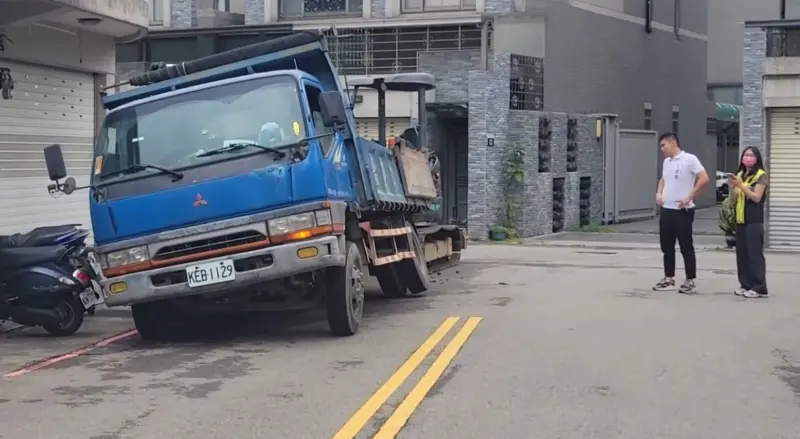 ▲里長江慶賢無奈的看著陷入路面的工程車。（圖／江慶賢提供，2024.06.05）