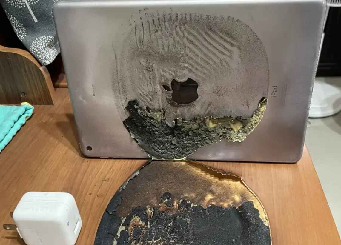 ▲有網友iPad 5在充電狀態下，突然燒起來，高溫甚至把桌面燒出黑炭，模樣相當驚人。（圖／翻攝Ptt）