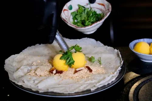 ▲潤餅皮加上冰淇淋、花生糖粉，以及香菜等，就是宜蘭名產「冰淇淋花生捲」。（圖／記者葉盛耀攝）