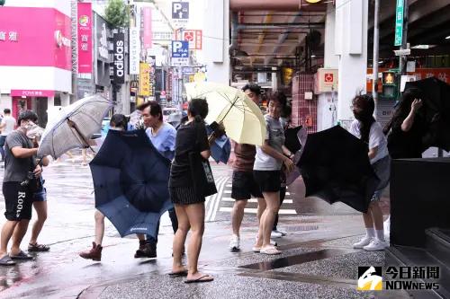 ▲凱米颱風來勢洶洶，台北不時有間歇式大風大雨，吹到行人雨傘似乎也抵擋不住強風豪雨。（圖／記者朱永強攝）