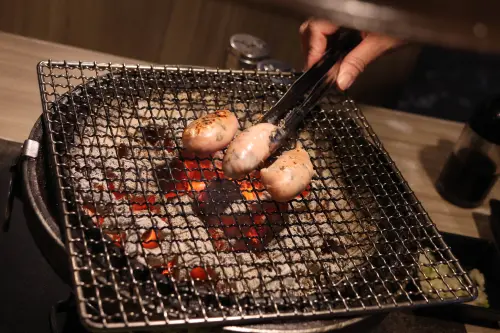 ▲炭剛點燃、火力逐漸上升時，可先烤香腸、雞肉及五花肉等油脂較豐富的食材。（圖／記者朱永強攝）