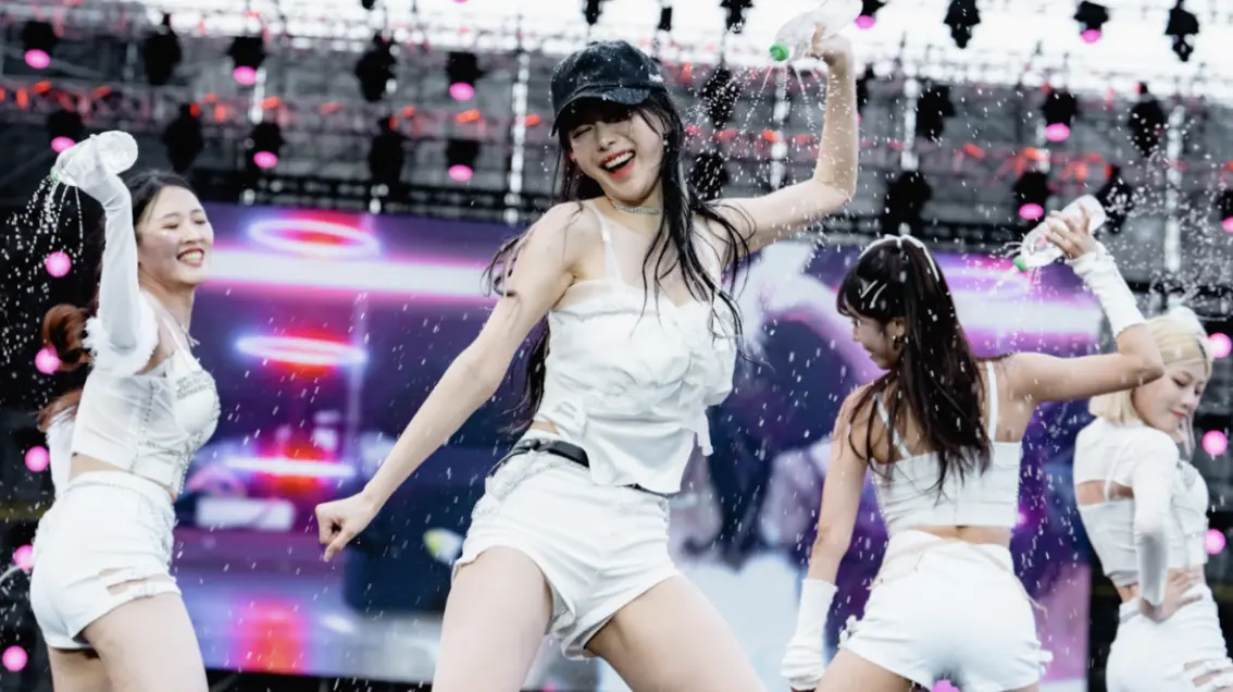 ▲2025高雄櫻花季第2天今（29）日在高雄夢時代前廣場展開，韓籍啦啦隊女神李雅英（中）將手中寶特瓶水從頭頂淋下，雪白肌膚與火辣身材一覽無遺，養眼福利滿足台下粉絲。（圖／寬寬整合行銷提供）