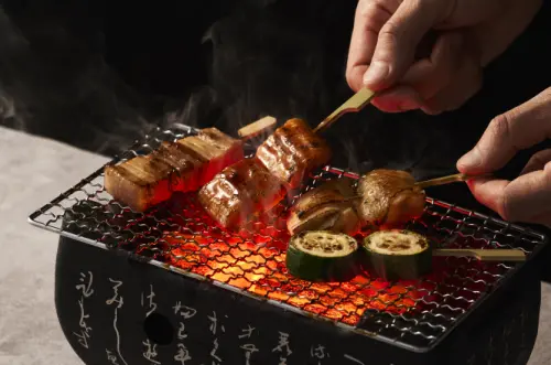 ▲饗賓「貓將壽司」串烤燒物蔬菜「玉米筍」80元起、肉類「手羽先」、「雞腿串」100元起。（圖／翻攝自貓將壽司官網）