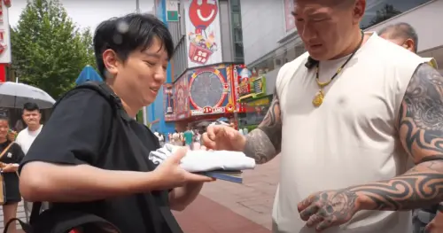 ▲小草拿出柯文哲的競選小物「KP Tshirt」，要求館長幫簽名。（圖／翻攝自YouTube館長惡名昭彰）