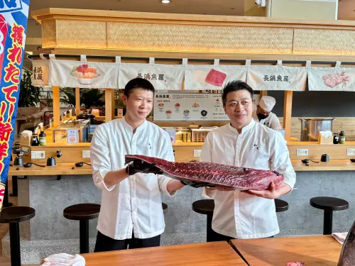 ▲「長浜魚屋・中和環球店」開幕日還由集團營運長黃永凱（右）親自示範整尾黑鮪魚分切秀。（圖／記者葉盛耀攝）