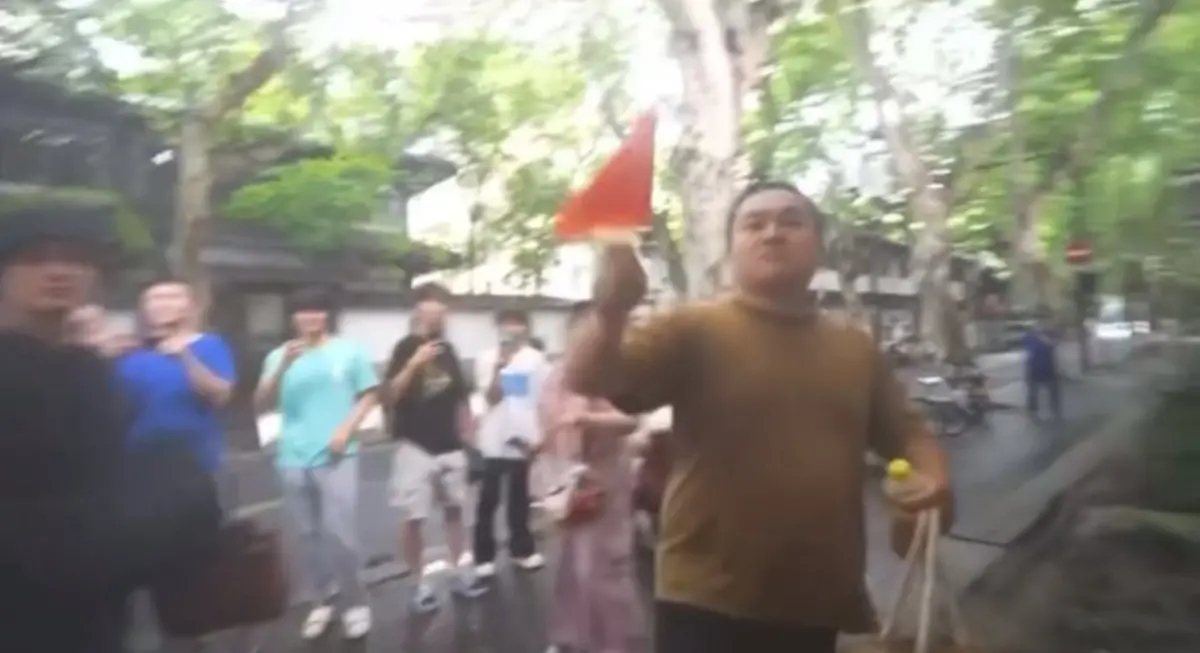 ▲網紅「館長」陳之漢訪中第五天，中午用完餐後，遭男子舉五星旗抗議痛斥「台獨狗」。（圖／翻攝自館長惡名昭彰YouTube）