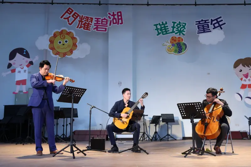 ▲信義房屋支持在地藝術文化，首次攜手台北大師星秀音樂節，由營運長林士凱領軍，與大提琴陳世霖、吉他孫家偉組成弦樂三重奏，於碧湖國小帶來經典組曲。（圖／信義房屋提供）