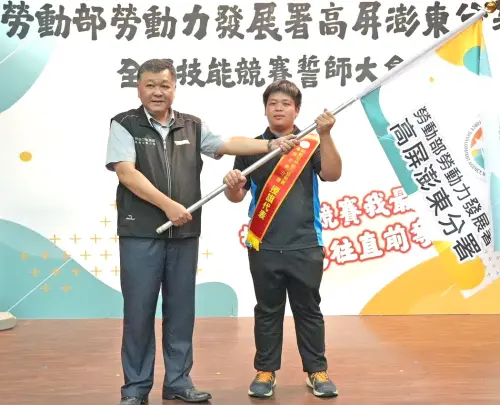 ▲在誓師大會活動中,由高屏澎東分署分署長郭耿華(左)代表授旗,由來自台灣科技大學的選手孫翊恩(右)代表接受。(圖/勞動部高屏澎東分署提供) ▲在誓師大會活動中,由高屏澎東分署分署長郭耿華(左)代表授旗,由來自台灣科技大學的選手孫翊恩(右)代表接受。(圖/勞動部高屏澎東分署提供)