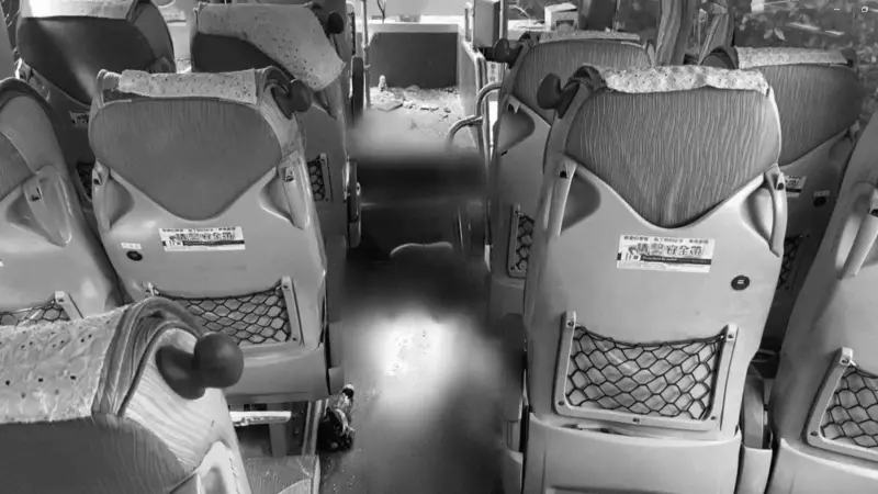 ▲國光客運前排座位的走道佈滿碎玻璃與大片血跡。（圖／翻攝畫面）