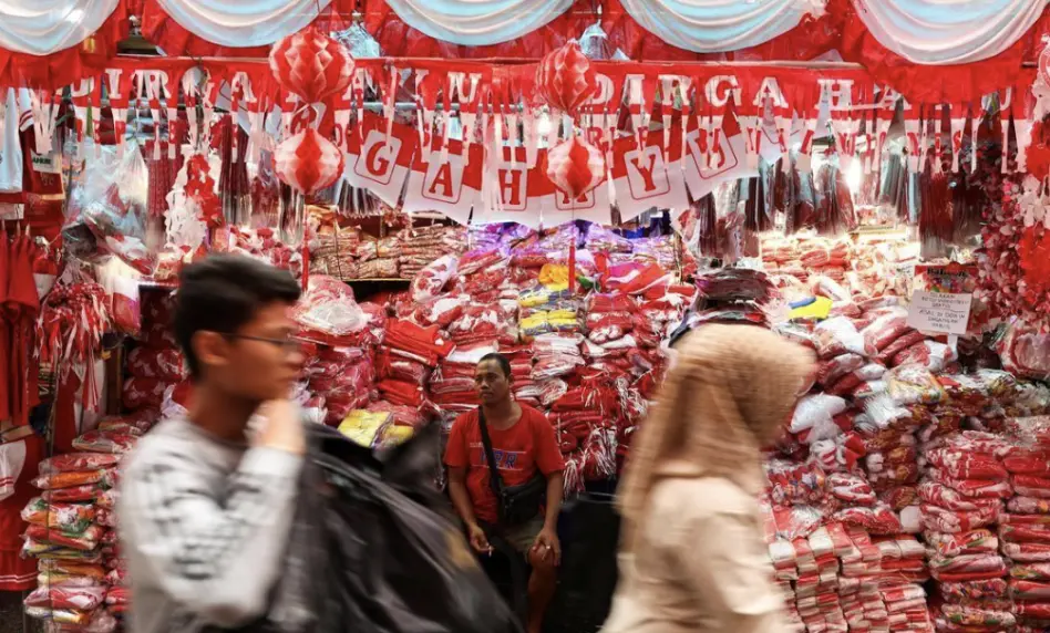 ▲近期印尼人民協商會議（MPR）討論重啟《國家建設總方針》，引發民主制度走向的辯論。圖為印尼雅加達小販販售國旗飾品與服飾，為8月17日獨立日慶典提前營造熱烈氛圍。（圖／路透社／達志影像）