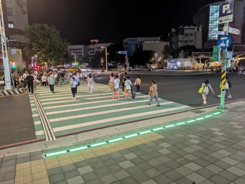 ▲新北市政府推出「行人地面警示燈」，率先在板橋府中捷運站試辦，以同步發光的LED地磚提醒行人和駕駛當前號誌燈態。（圖／新北市交通局提供）