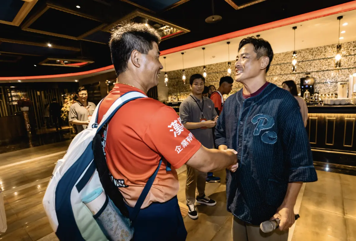 ▲江宏恩（右）在慶功宴上和東園少棒總教練賴敏男（左）相談甚歡，想到過去自己在棒球隊受訓時還被打耳光，敲手指關節，和現在愛的教育差很大。（圖／美福、台北市政府提供）