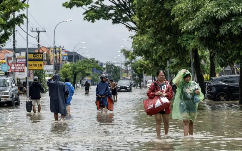 ▲印尼峇里島豪雨成災，首府登巴薩多處街道淹水，居民居民涉水撤離。（圖／路透社／達志影像）