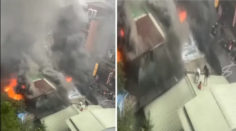 ▲新北市木柵區一棟民宅今早突發生大火，民眾抱著小孩趕忙上屋頂避難。（圖／翻攝自「木柵社團」臉書）