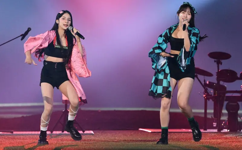 ▲富邦悍將Fubon Angels女孩「寵愛天使」主題日，潔潔、Kapo不僅穿上禰豆子、炭治郎服裝，唱跳搖滾版的鬼滅之刃主題曲《紅蓮華》，潔潔表演最後爬上3層樓高的桿頂「高空作業」，彷彿特技演出，引爆全場球迷歡呼，更有人直呼：「這表演太危險！」（圖／記者林柏年攝,2025.09.20）