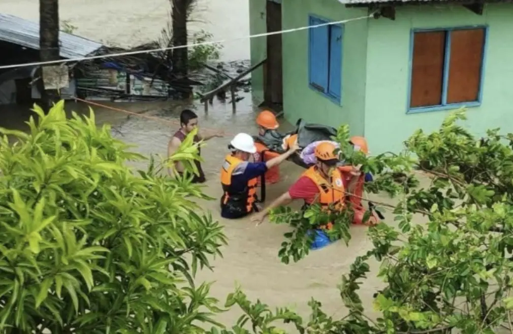 ▲菲律賓呂宋島南部因颱風博羅依（Bualoi）肆虐嚴重淹水，救難人員涉水協助居民撤離家園。（圖／美聯社／達志影像）