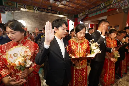 ▲南投縣政府今日在日月潭文武廟舉辦集團婚禮，30對新人身著中式龍鳳褂相偕出場，在月老見證下互許終身。（圖／縣府提供）