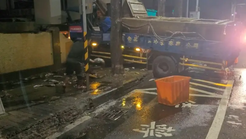 ▲大貨車自撞圍牆，鱸魚掉落地面死亡。（圖／翻攝畫面）