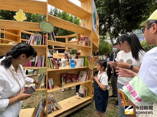 ▲由景觀協會提供的原木大書架，陳列滿滿各類二手書籍，歡迎愛書民眾自由帶走，（圖／記者金武鳳攝，2025.11.2)