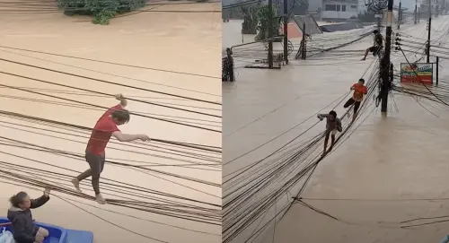 ▲泰國發生歷史性洪災，數名男子在搖晃的電線上行走，尋找安全地點。（圖／翻攝自影片）