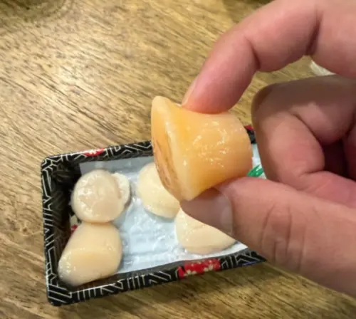 ▲有顧客買一盒頂級干貝，結果發現之中混入一顆橘色干貝，緊急詢問老闆這是不是壞掉不能吃。（圖/Threads@漁爸海鮮）