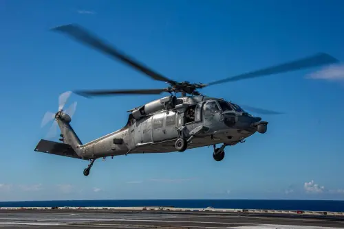 A helicopter hovering above the deck of the USS Abraham Lincoln. (Facebook USS Abraham Lincoln CVN 72)