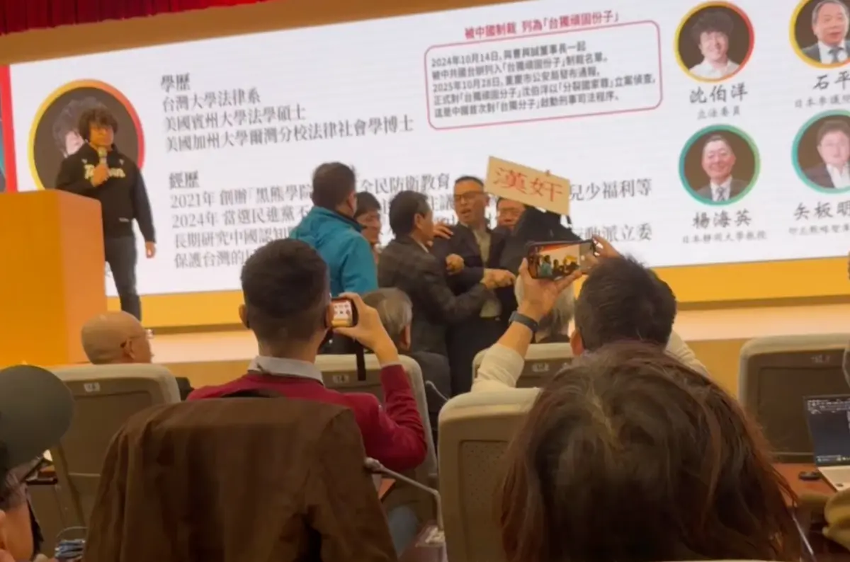 ▲印太戰略智庫今（9）日舉辦研討會，新黨副秘書長游智彬舉著「漢奸」的牌子進來鬧場，引發現場一陣騷亂。（圖／記者陳政嘉攝）