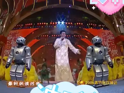 ▲▼劉德華唱到中段時，前方出現兩隻小型機器人，它們做出半蹲、起身、揮舞雙手等動作，還能模擬真人隨音樂做出身體律動。（圖／ CCTV 中文臉書）