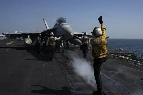 An US Navy EA-18G prepares to launch from the flight deck of an aircraft carrier. (US Department of War)