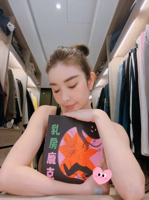 ▲許維恩用書本遮在胸前，卻還是不小心露點，她事後改用貼圖遮住重要部位。（圖／許維恩臉書）