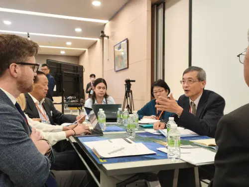 Economist Lee speaks as other participants listen at the TTX. (TCN)