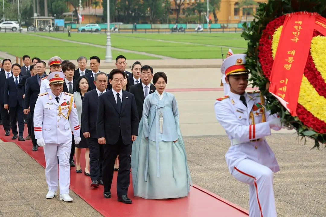 ▲南韓總統李在明（中）偕夫人於河內出席官方儀式，向胡志明陵獻花致意，展開對越南國是訪問行程，雙方高層隨行出席。（圖／路透社／達志影像）