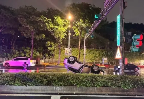 ▲ 23日晚間8時許，北市士林中山北路五段口，74歲楊男駕車雨夜失控翻覆四輪朝天，載70歲張女受傷送醫。（圖／翻攝畫面）