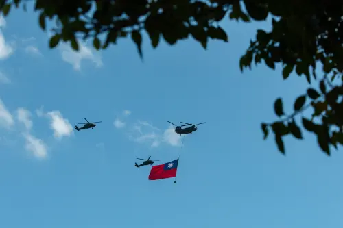 ROC Army helicopters fly in formation carrying the Republic of China (Taiwan) national flag during the National Day celebration. (Office of the President)