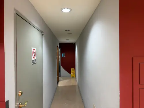 ▲校方提供現場照片顯示，該具爭議鏡頭設置於男廁旁牆角，拍攝方向朝向公共走廊而非廁所內部。校方坦言早期裝設初衷是為了治安追查，未來將全面更換為具警示作用的標準型監視器。（圖／輔仁大學提供）
