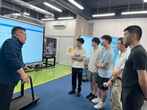 An Alpha Ring employee explains the Alpha-E system to university students. (Alpha Ring)