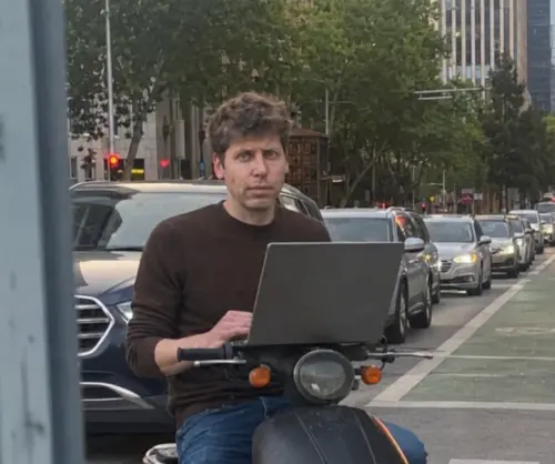 OpenAI CEO Sam Altman uses a laptop. (Facebook, OpenAI)