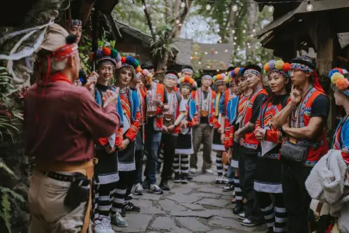 Couples in traditional Tsou attire listen to a tribal elder during the 2026 Alishan Starry Wedding Tour. (Taiwan Tourism Administration)
